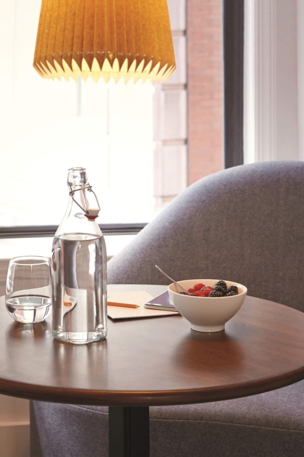 A glass water jug and breakfast in a Suite at The James NoMad Hotel