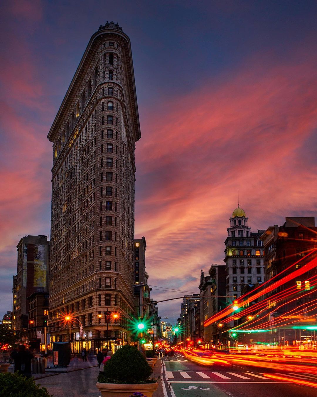 The Flatiron Building in NYC with cotton candy skies in the background